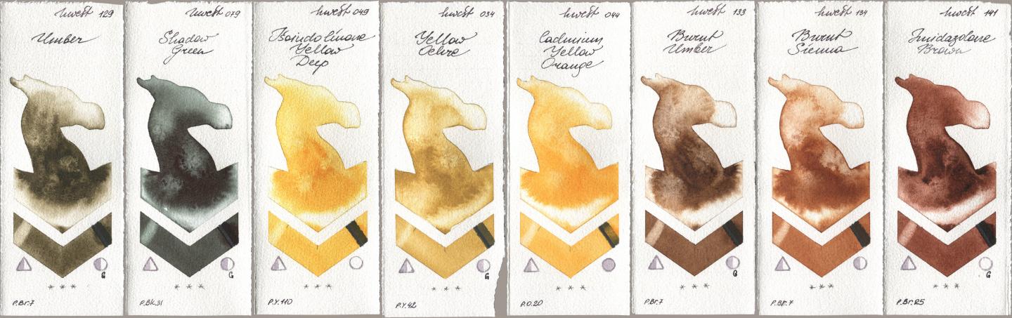 Holbein Artists Watercolor 129 Umber, 079 Shadow Green, 049 Isoindolinone Yellow Deep, 034 Yellow Ochre, 044 Cadmium Yellow Orange, 133 Burnt Umber, 134 Burnt Sienna, 141 Imidazolone Bro watercolor swatch